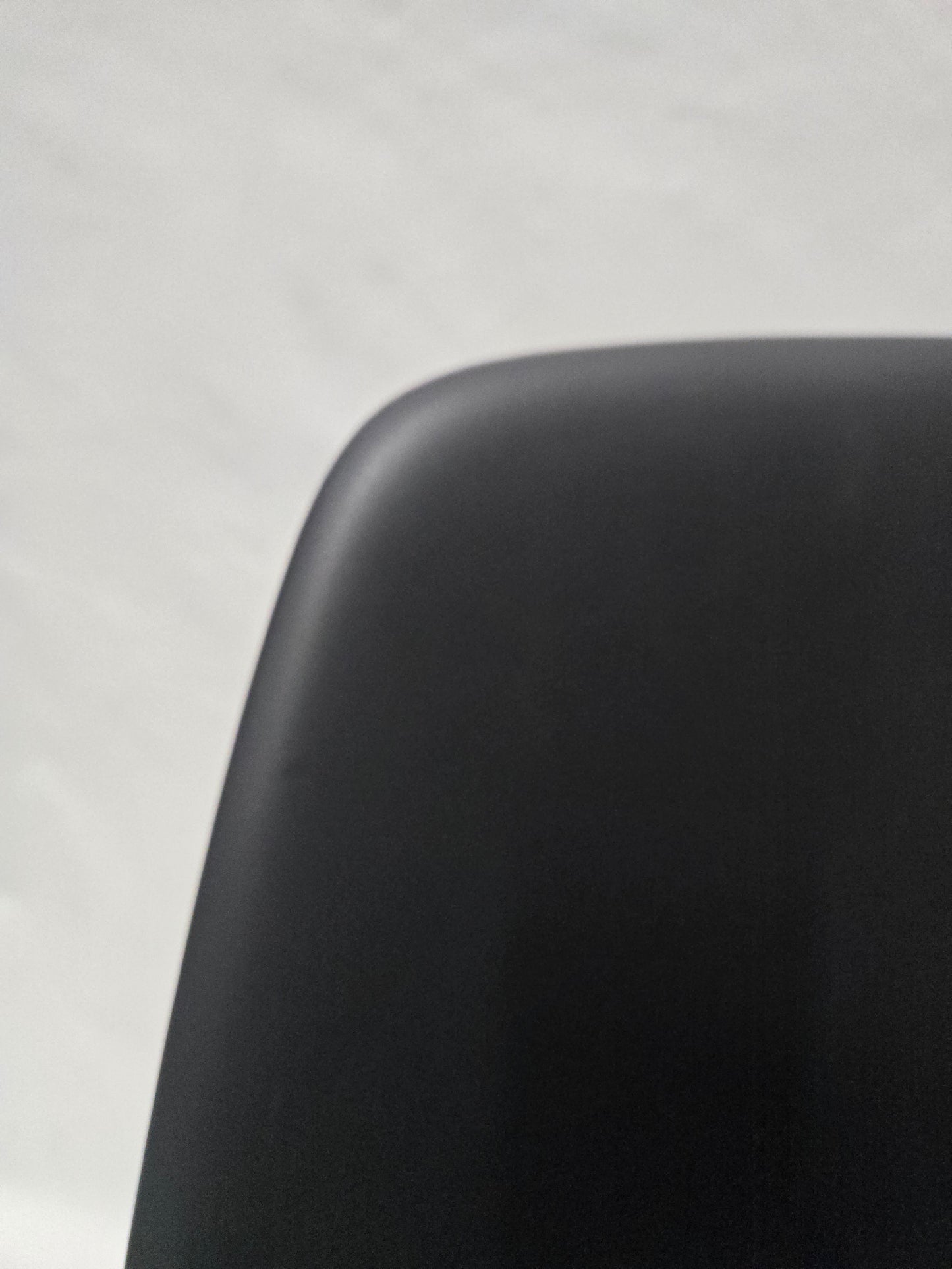 Vitra Eames Plastic Molded Chair in Black with Grey Cushion
