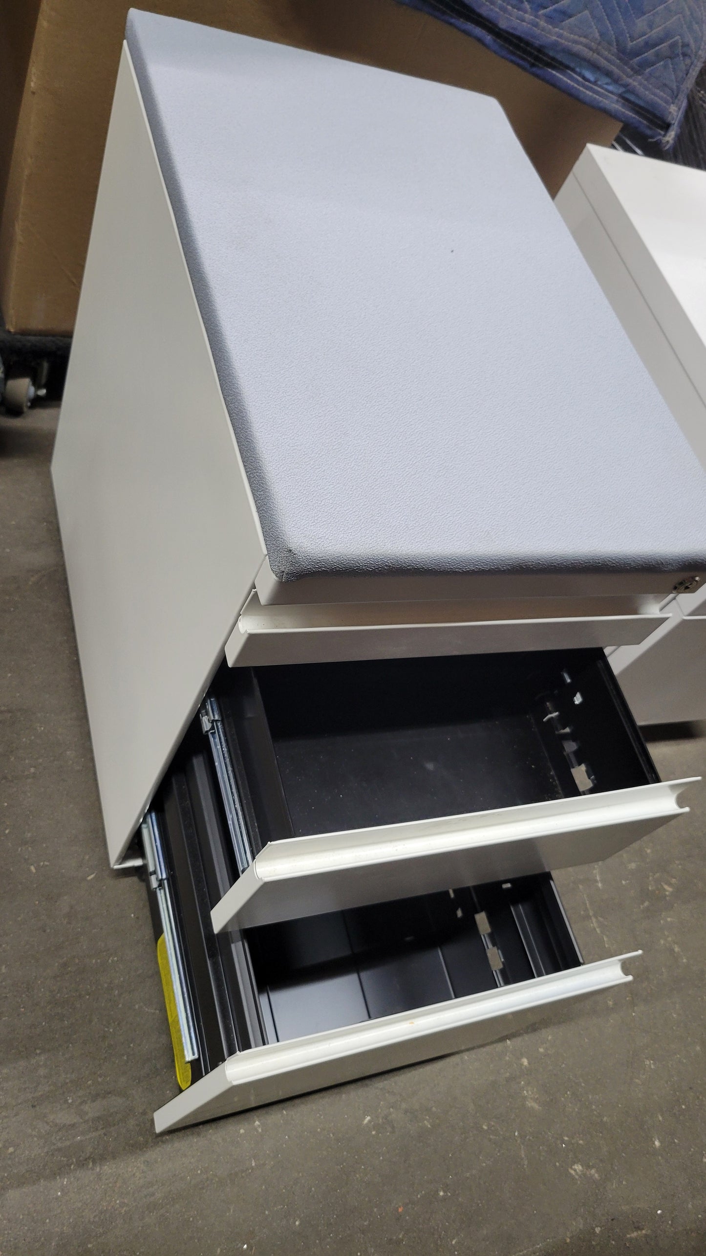 Haworth Three-Drawer Mobile Filing Pedestal in White with Upholstered Seat in Light Blue / Grey
